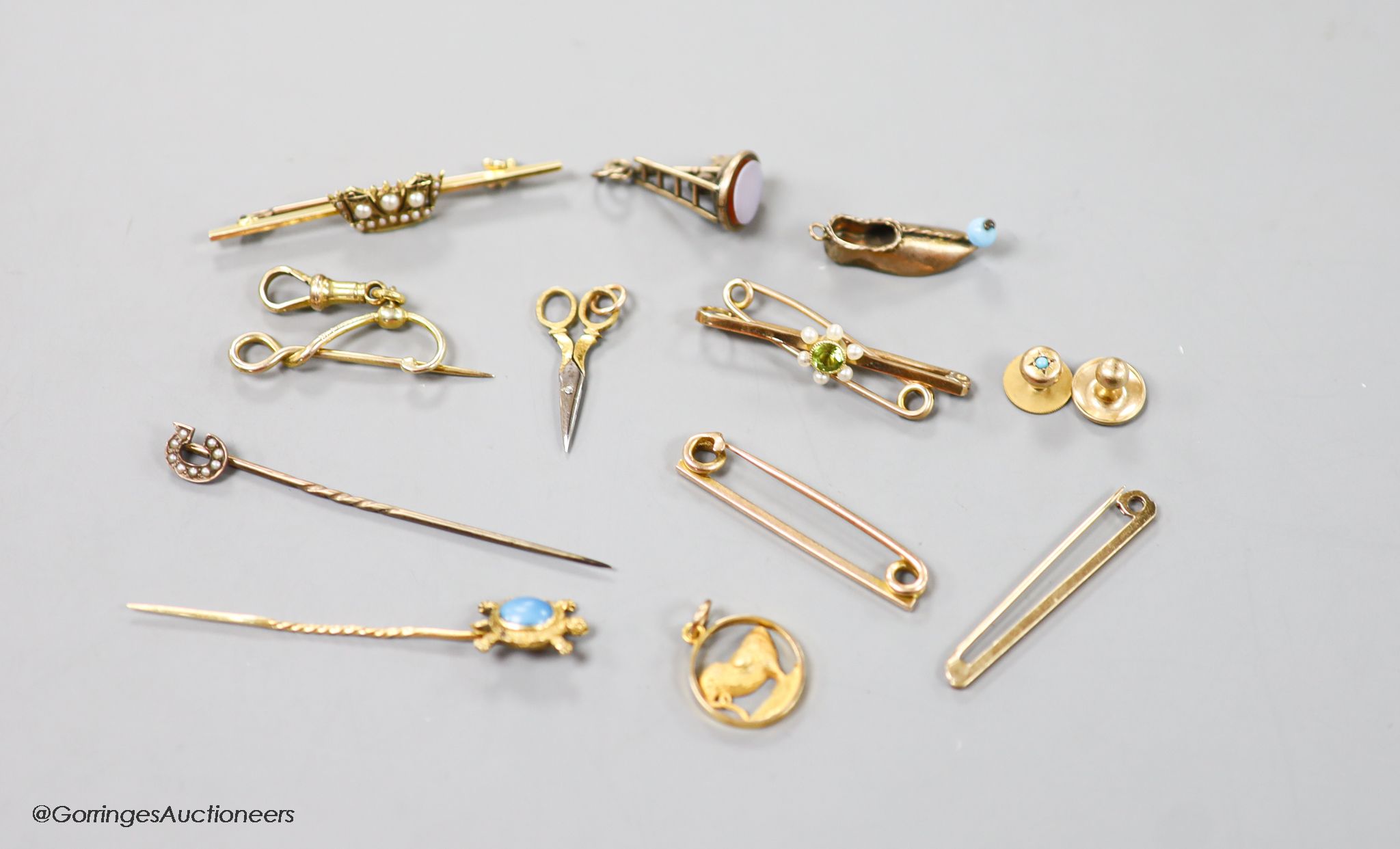 A small collection of stick pins, 'ladder and key' fob seal, bar brooches and charms etc. including 15ct and seed pearl coronet bar brooch, 50mm, gross 3.4 grams